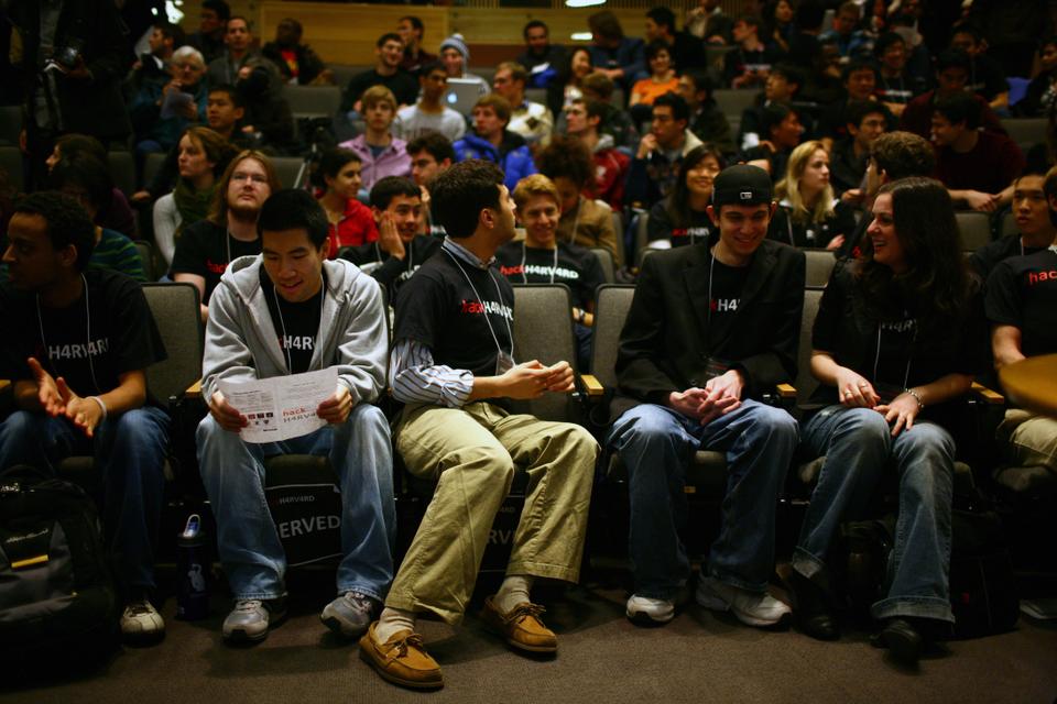 Students and computer professionals listen to presenters at the Hack Harvard showcase on Sunday. The event, held in Fong Auditorium, featured 13 student-teams who presented their software designs. 