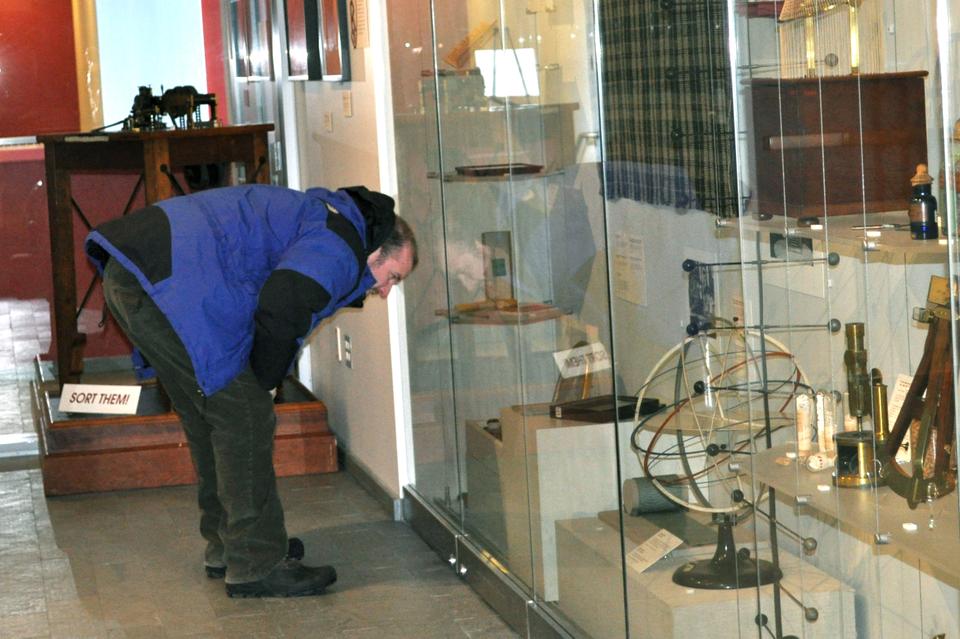 Philip C. Mead, a history graduate student, examines a belt worn by officers in the Harvard Washington Corps at the new Tangible Things exhibition at the Science Center. The exhibition, open from 11 a.m. to 4 p.m. Monday through Friday, features roughly 200 objects from Harvard’s massive collections, such as a beetle necklace, parasitic tapeworm, and tortilla from 1897. 