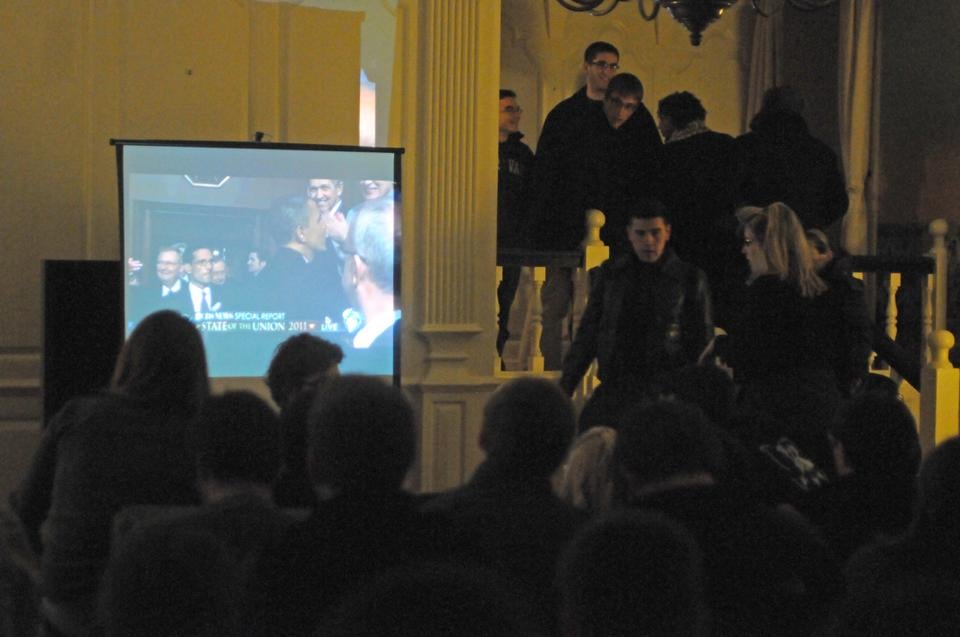 Students file into a packed Lowell Junior Common Room at the State of the Union watch party organized by the Harvard Democrats Tuesday night.