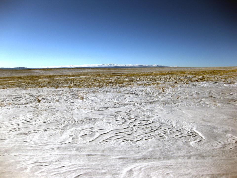 The snow is starting to melt on this field, but it won't be long until another snow storm hits and covers it again.