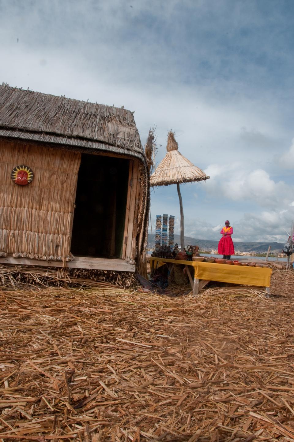 A salesperson waits to greet tourists at her stand on the largest floating island of Uros, located on the Peruvian side of Lake Titicaca. The Uros are a pre-Incan people who use totora reeds to build their houses, boats, and the islands themselves which are human-made. These islands are a large tourist attraction for travellers to the Peruvian town of Puno.
