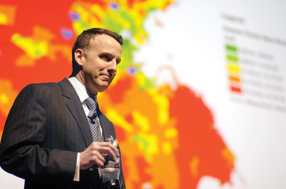 Economics Professor Edward Glaeser finishes his ten minute lecture during "Harvard Thinks Big II" on the benefits of living in cities with a graphic that expresses how less energy is used per capita in the most urban parts of the greater Boston area.