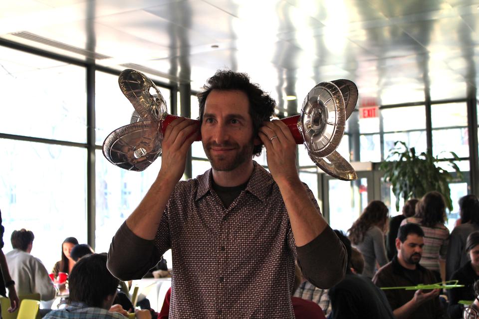 Steve Bobrow demonstrates how to use the ear extensions he just built out of foil plates and solo cups.
