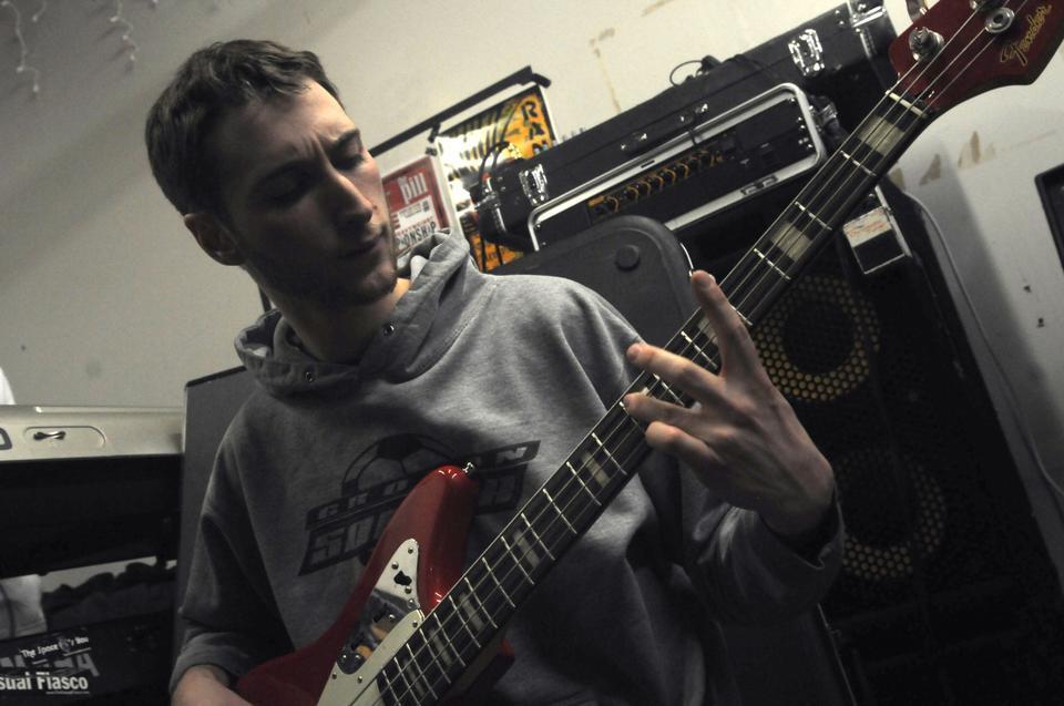 Third Rail guitarist, Sam Berman-Cooper, tunes his guitar in preparation for practice.