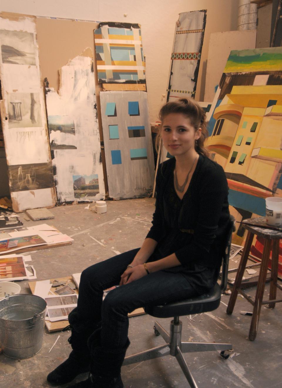 VES concentrator Julia Rooney '11 sits among a small selection of her paintings in her Linden Street studio space.