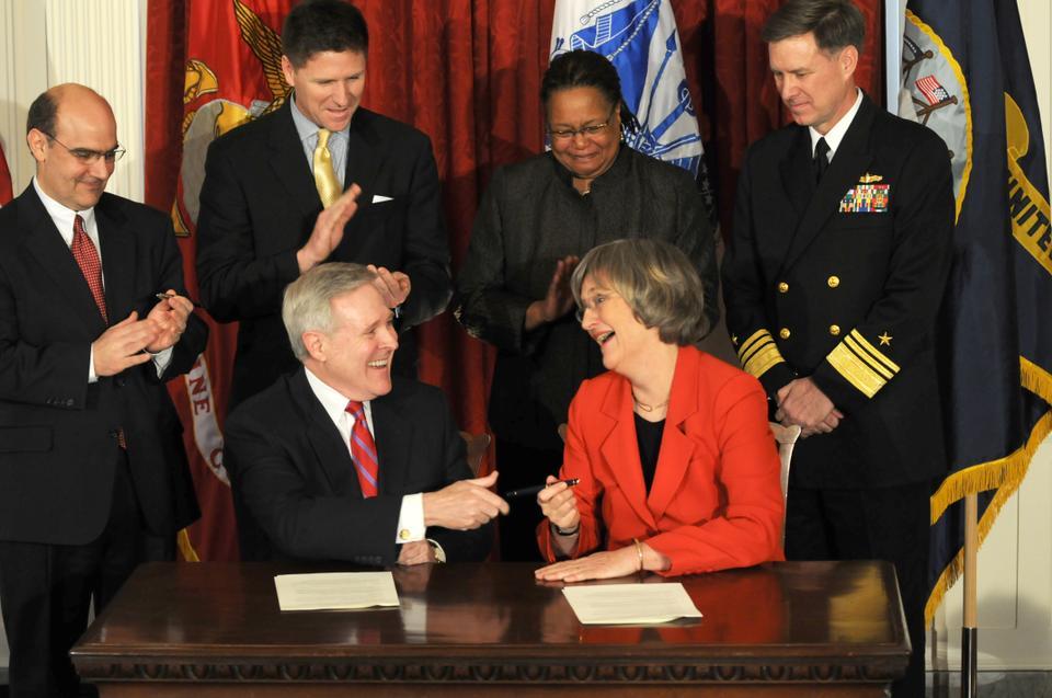 Navy Secretary Ray E. Mabus (seated, left) and Harvard University President Drew G. Faust (seated, right) sign an agreement Friday afternoon to re-establish the Naval ROTC at Harvard after nearly 40 years of absence due to Harvard's non-discrimination policy.