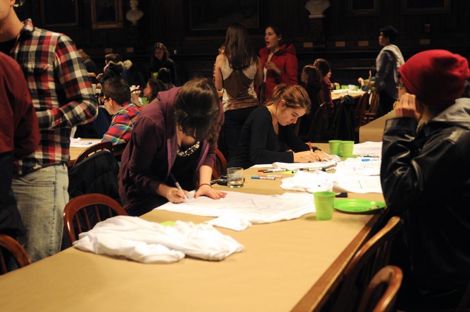 Freshmen decorate blocking group t-shirts at last night's "Fresh Fest." Students had the opportunity to make balloon animals and get henna tattoos during the evening. 