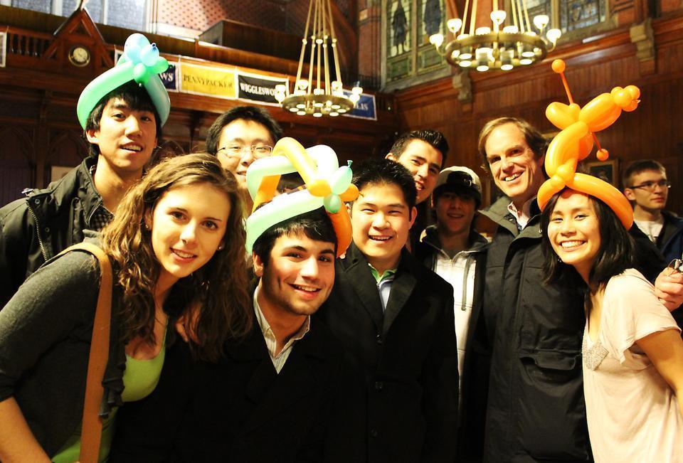 Dean of Freshmen Thomas A. Dingman '67 poses with freshmen at the  event hosted by the First Year Social Committee on Housing Day Eve. 