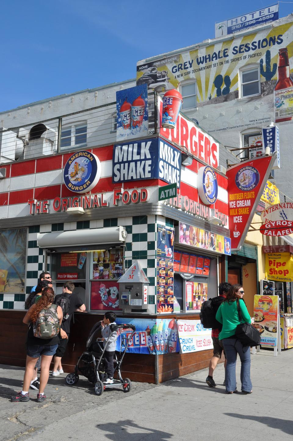 The stores that line the Venice Beach Boardwalk are known for their cluttered exterior appearance and are often decorated with brightly colored signs that advertise the goods they sell.  Their exterior blends in with the colorful street art that can be spotted around the boardwalk.