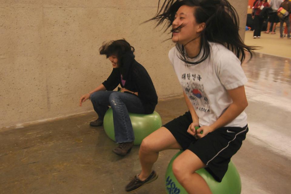 Students bounce on bouncing balls yesterday in the “Happynest,” a space created in an attempt to make Harvard happier. 