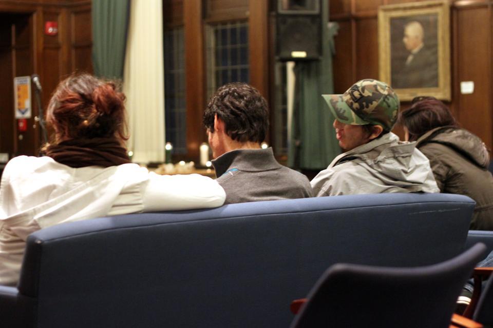 Students listen to an anonymous testimonial at an immigration vigil held Thursday night at the Harvard Divinity School. The vigil, organized by a group from HDS Borderlinks, included testimonials, music, and responses from community members.