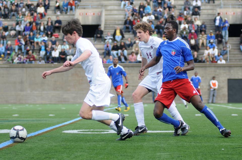 The Harvard Varsity soccer team played the Haitian National team yesterday at the Harvard stadium in order to raise funds for Haiti. Team co-captain Scott Prozeller '12 drives the ball forward while teammate Kyle Henderson '13 holds off a Haitian player. 
