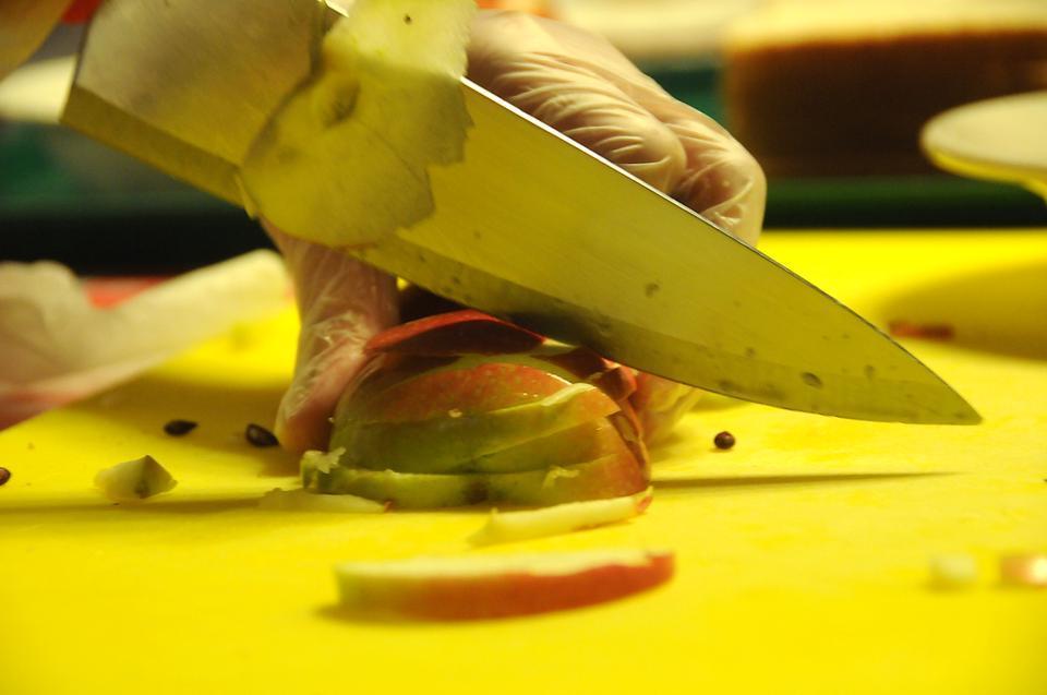 A competitor slices an apple as part of the final round of Top Chef Harvard at Annenberg yesterday.