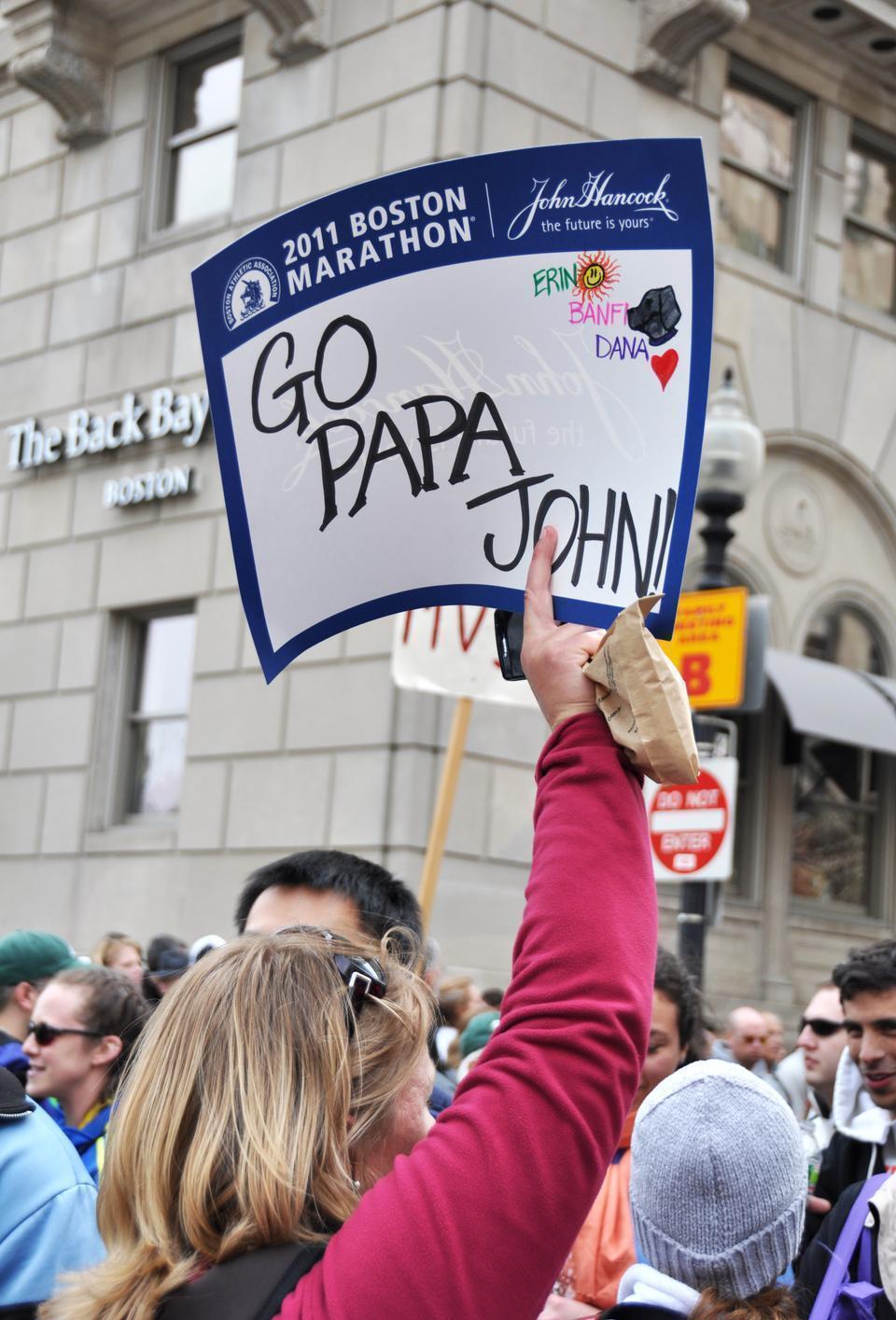 Spectators cheer on their friends and family during yesterday's marathon.