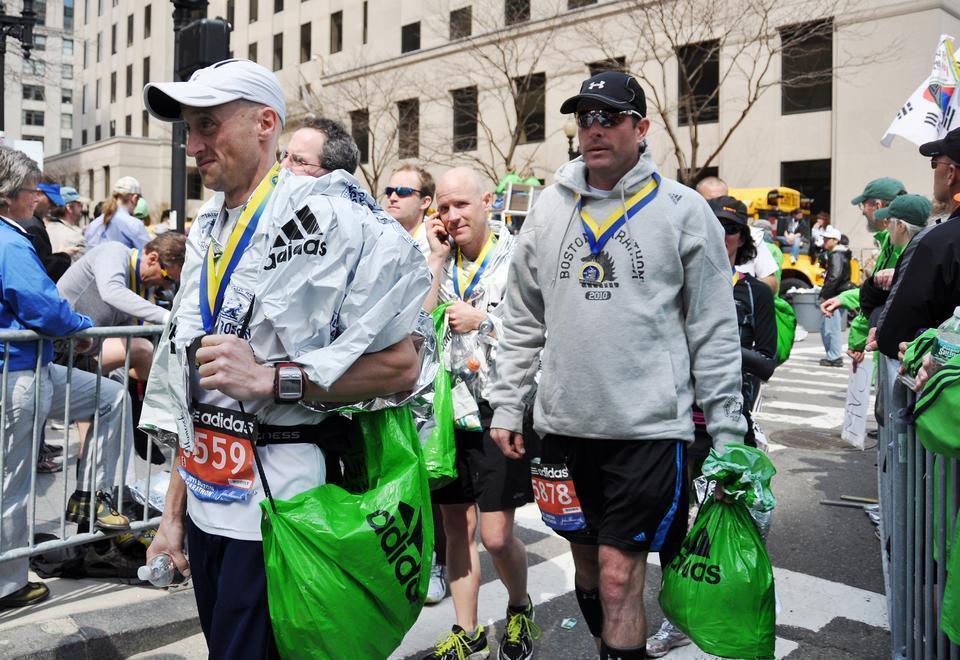 Runners walk away from the 26.2-mile race with their finisher's medals. 