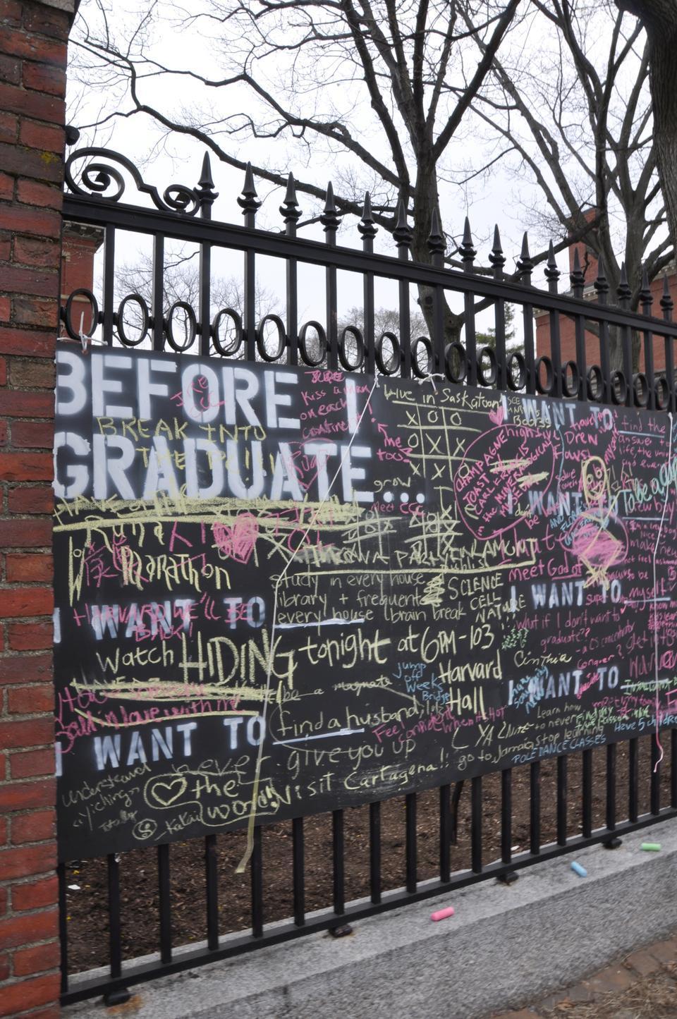 Students have written about before graduation aspirations on a chalkboard ‘bucket list’ between Thayer Hall and the Science Center yesterday.