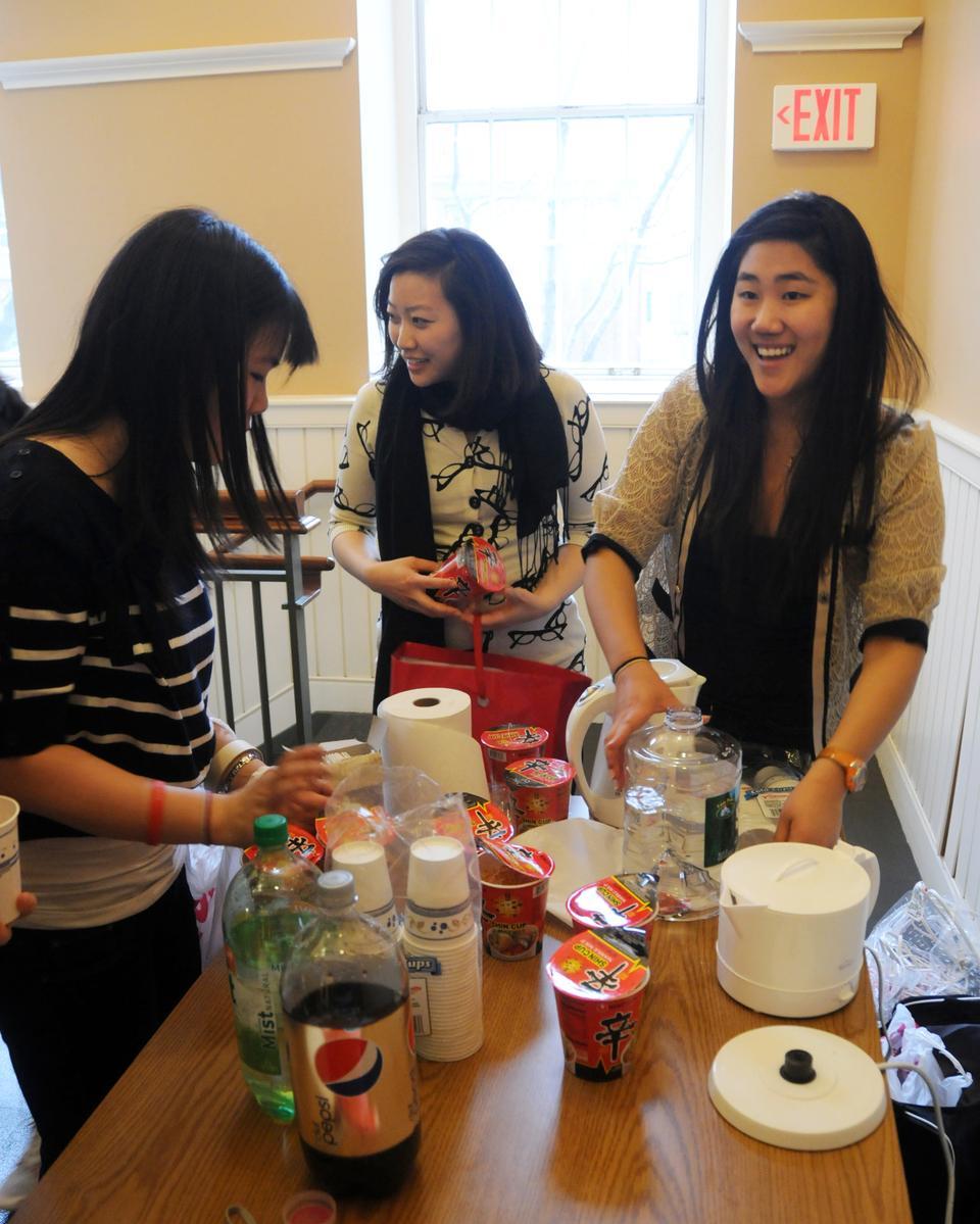 Elena H. Chit ‘12, Ja-yoon Choe ‘12, and Janet J. Wee ‘11, prepare free ramen for the audience prior to a screening of “Hiding”, a documentary about a rescue of North Korean refugees from China in Harvard Hall yesterday.  