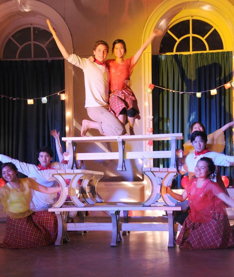 Student members of HPF (Harvard Philippine Forum) dance on top of benches for the Sayaw sa Bangko, a folk dance that originated from the Pangasinan province of the Philippines.