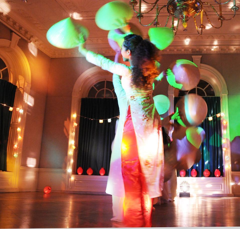 The Harvard Vietnamese Dance Troupe performs an original dance piece involving traditional Vietnamese hats and colorful costumes.
