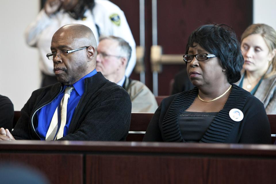 Gregory Daniel Cosby and Denise Cosby, the uncle and mother of murder victim Justin Cosby, look on from the front row of the courtroom as the jury foreperson announces the verdict.
