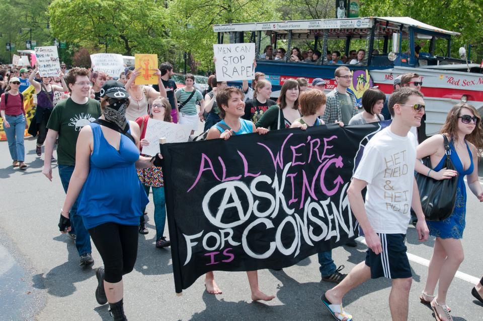 Vicky E. Koski-Karell '12 (banner center), joins the many hundred's of marchers during the Boston Slutwalk to raise awareness for sexual violence against women.