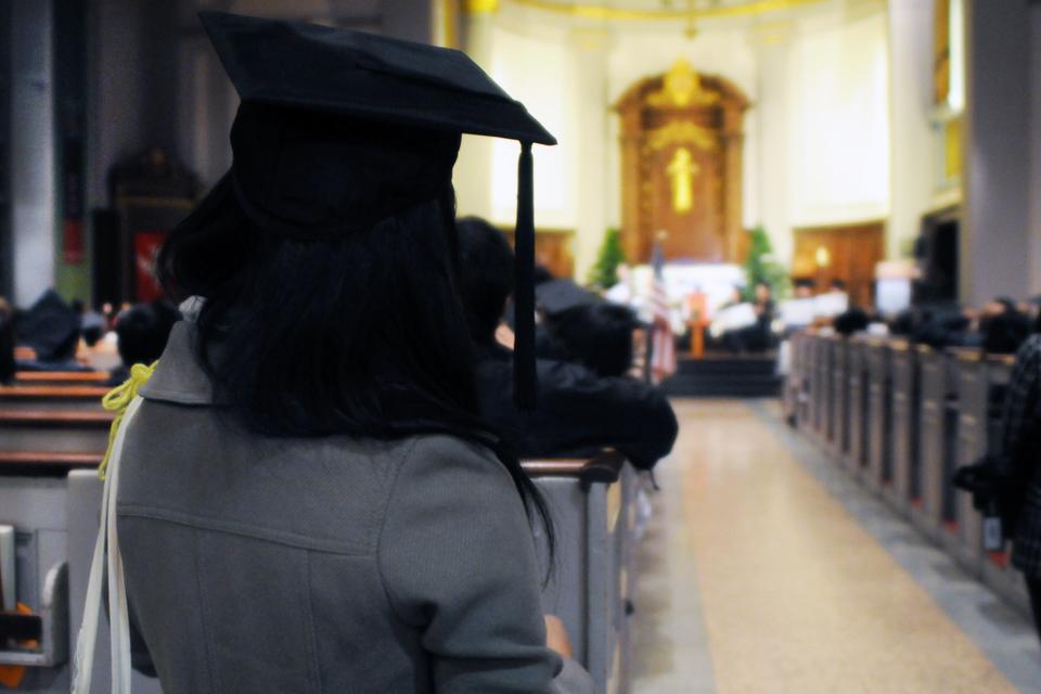 An activist from the Students Immigrant Movement wears a graduation cap in support of the DREAM Act during a rally held in Cathedral Church of St. Paul on Nov. 29, 2010. 
