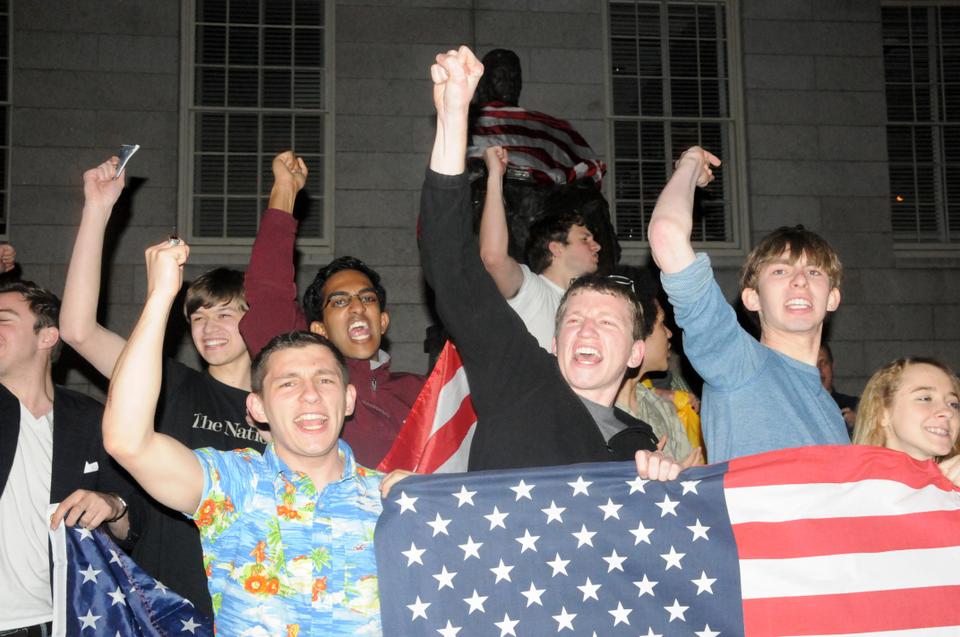 Following Osama Bin Laden’s death, students celebrate in front of the John Harvard statue by draping an American flag over the University icon. Chants of “U-S-A” filled the air as students flooded the Yard.