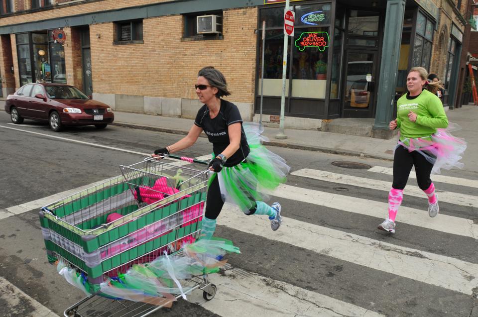 Competitors race down Massachusetts Avenue while competing in the Urban Iditarod with shopping cart sleds. 