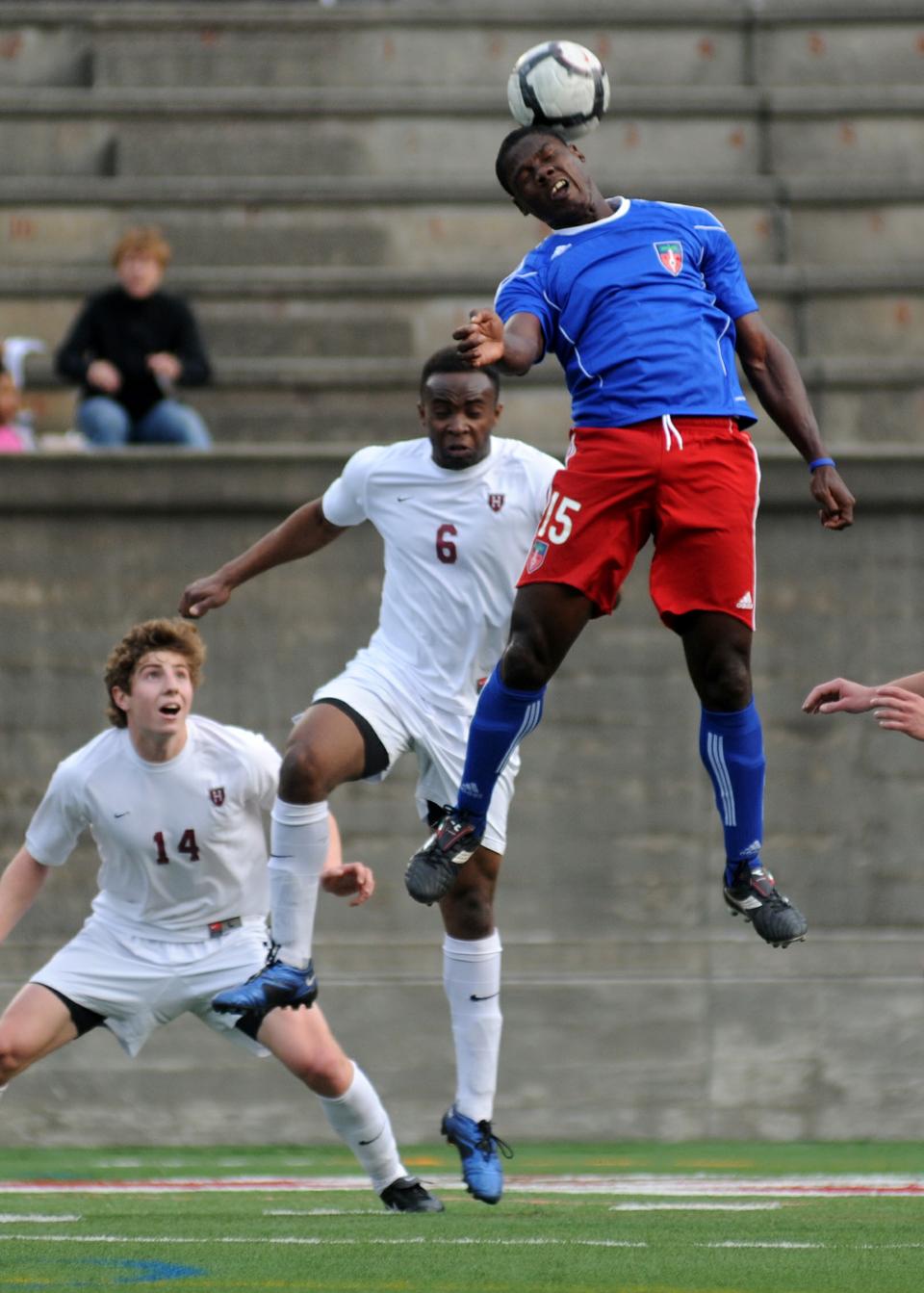 A member of the Haitian national soccer team heads a ball during a charity exihibition game against Harvard men’s soccer. 

