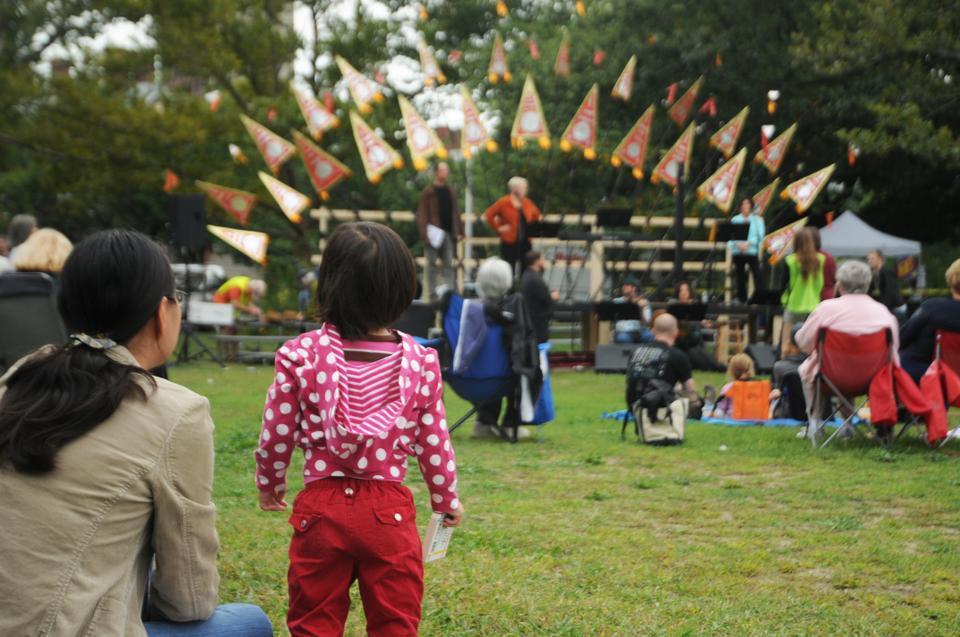 Families gather by Weeks Footbridge on the Cambridge side of the Charles river to enjoy the 7th annual Revels RiverSing, a community event celebrating the autumnal equnox.