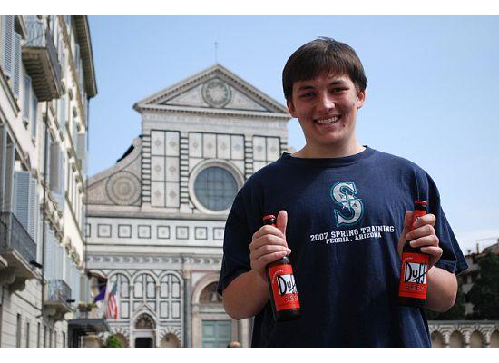 Alexander Koenig shows off his Duff beer in front of Florence’s Basilica of Santa Maria Novella.
