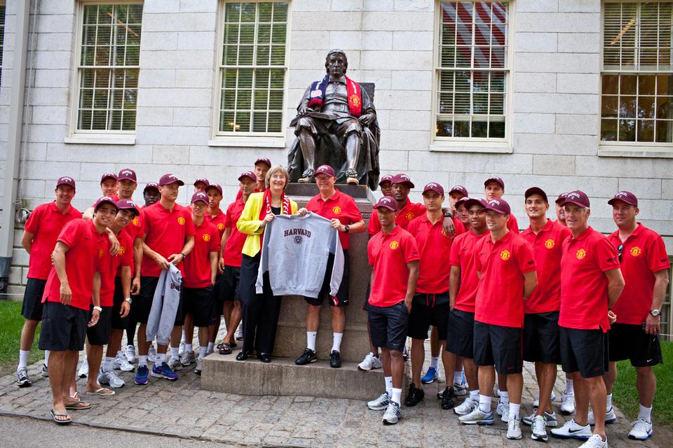 Members of the British soccer team Manchester United pose with University President Drew G. Faust.