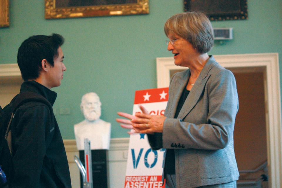 Harvard University President Drew G. Faust and Holworthy resident Daniel K. Roland ‘15 share a word by the voter registration booth set up in University Hall through the Institute of Politics yesterday.
