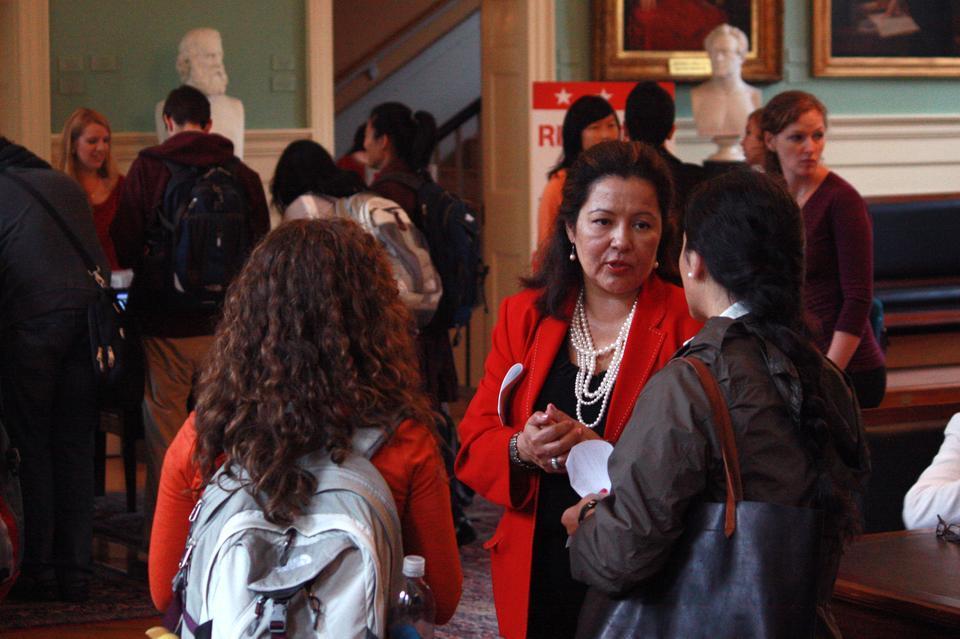 Noelia Rodriguez, Forum Director at the Institute of Politics and former Press Secretary for First Lady Laura Bush, talks to first year students as they turn study cards in at University Hall yesterday.