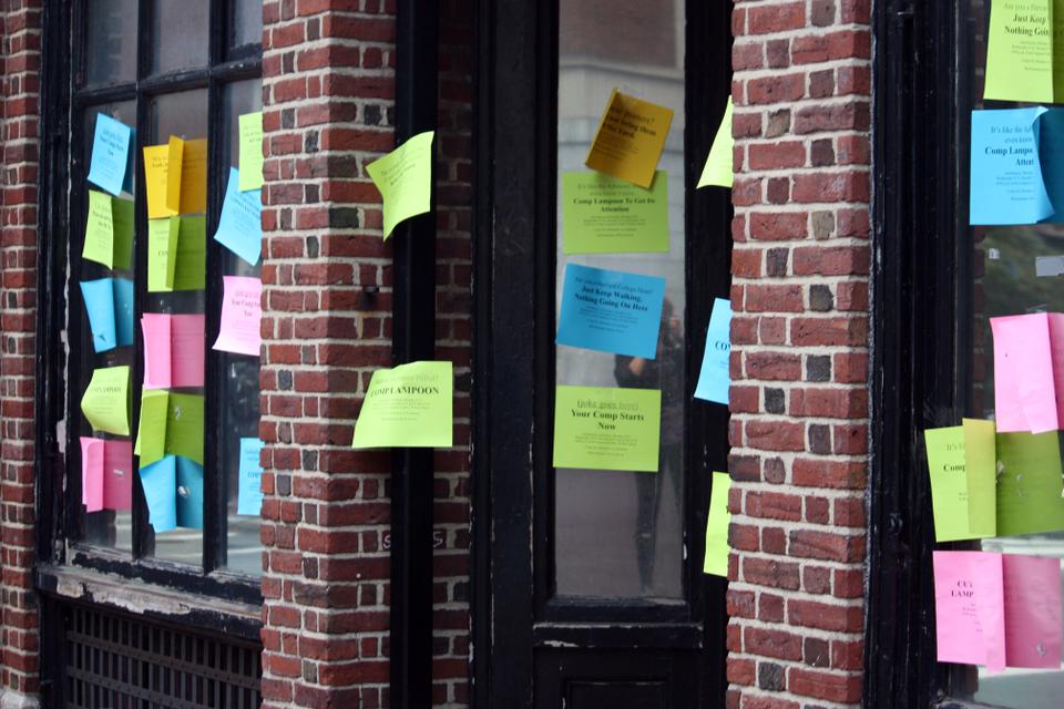 A semi-secret Sorrento Square social organization that used to occasionally publish a so-called humor magazine is covered in its own unamusing comp fliers on the corner of Bow and Mt. Auburn Streets.