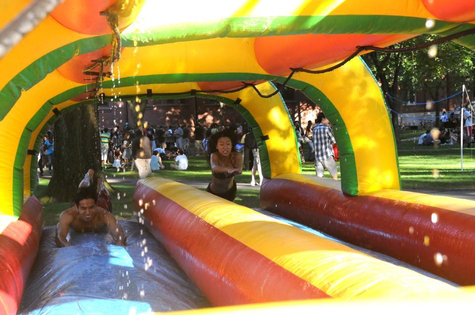 Robert K. Nishihara '13 and Yiren Lu '13 take advantage of the last glimmer of summer and enjoy the slip n' slide at Cape Crimson, this year's student welcome event.