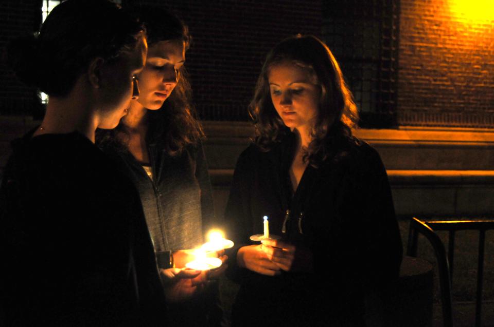Three students light each others candles in Tercentenary Theatre during the Candle Light Vigil held Sunday night in memorium of the September 11th attacks.  Students gathered here during the tenth anniversary of the tragedy in New York to remember those who were lost.