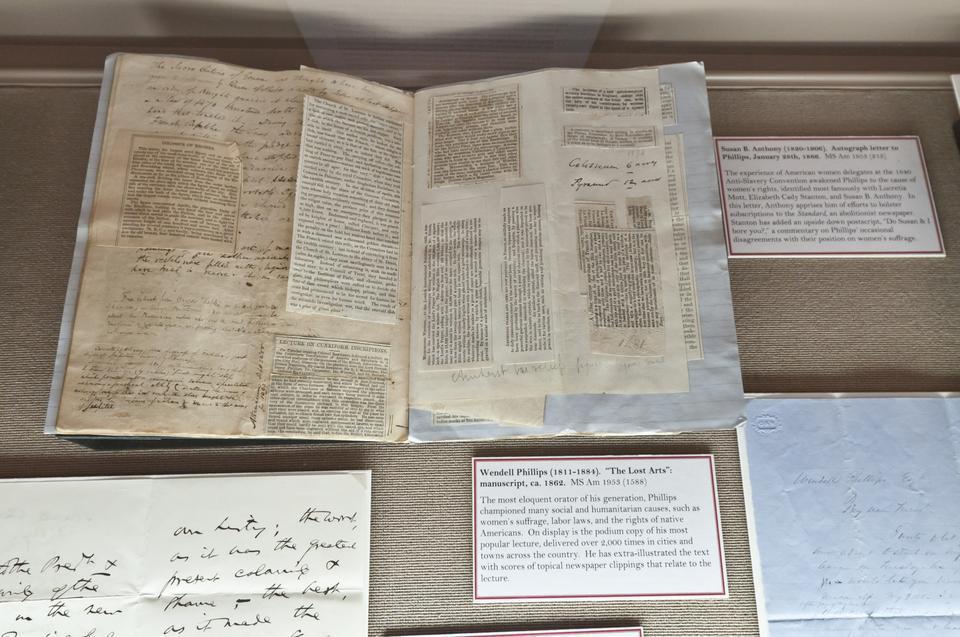 Newspaper clippings gathered by Wendell Phillips sit on display with many other historically significant documents, including a note from Susan B. Anthony.