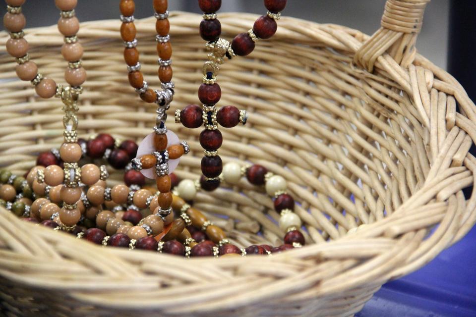 Vendors sell silver jewelry and wooden beaded necklaces, including these beaded crosses, during the festival.