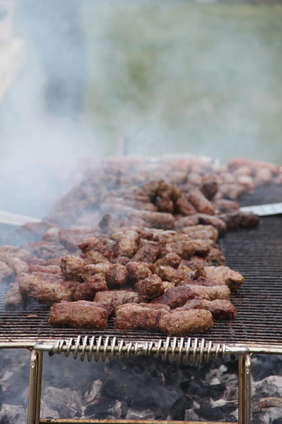 Traditional Serbian sausages, Cevapcici, roast on an open barbecue.