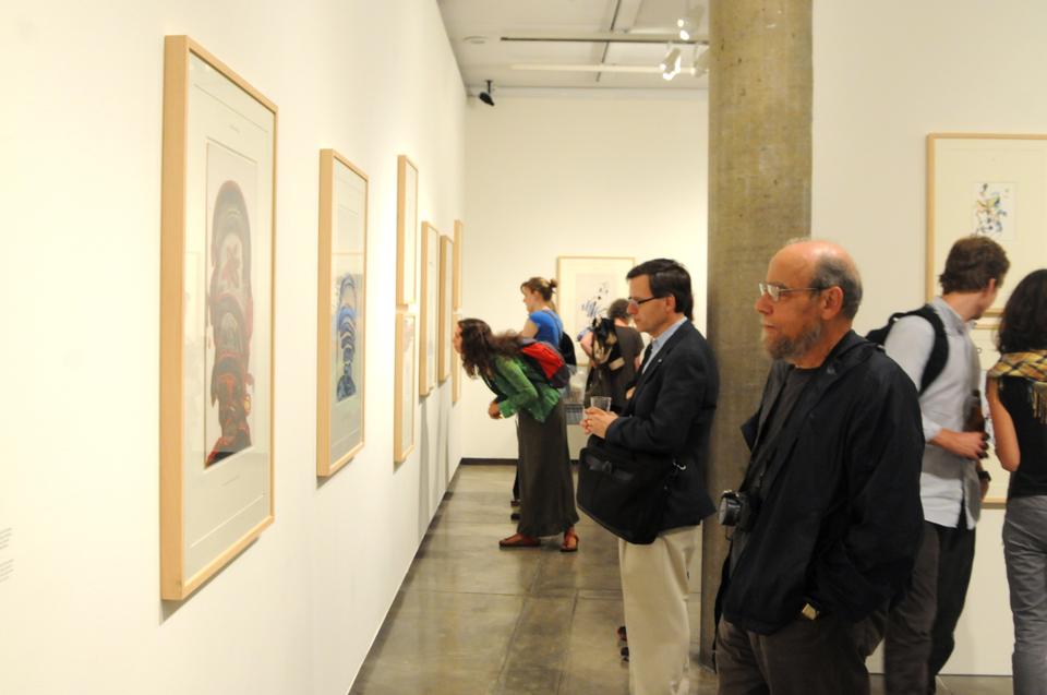 Visitors admire the work of Swiss artist Pavel Schmidt at the Sert Gallery in the Carpenter Center.  Schmidt visited the Carpenter Center to discuss these drawings, which are largely based on Franz Kafka's narratives.