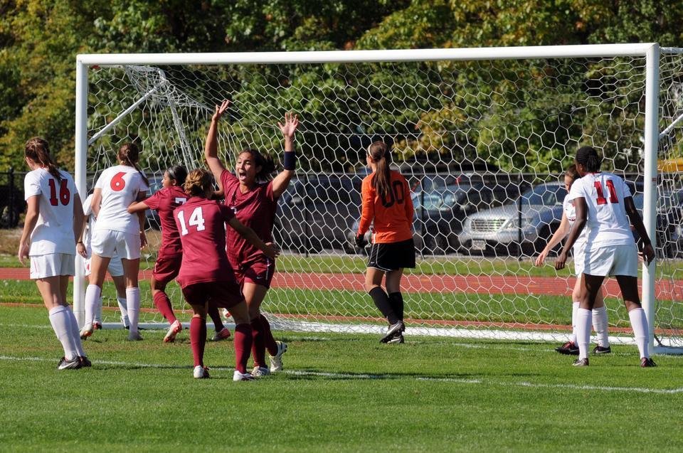 Junior midfielder Aisha Price scores Harvard's first goal against Cornell on Saturday afternoon. The matchup between the two teams ended in a deadlock, 2-2. 