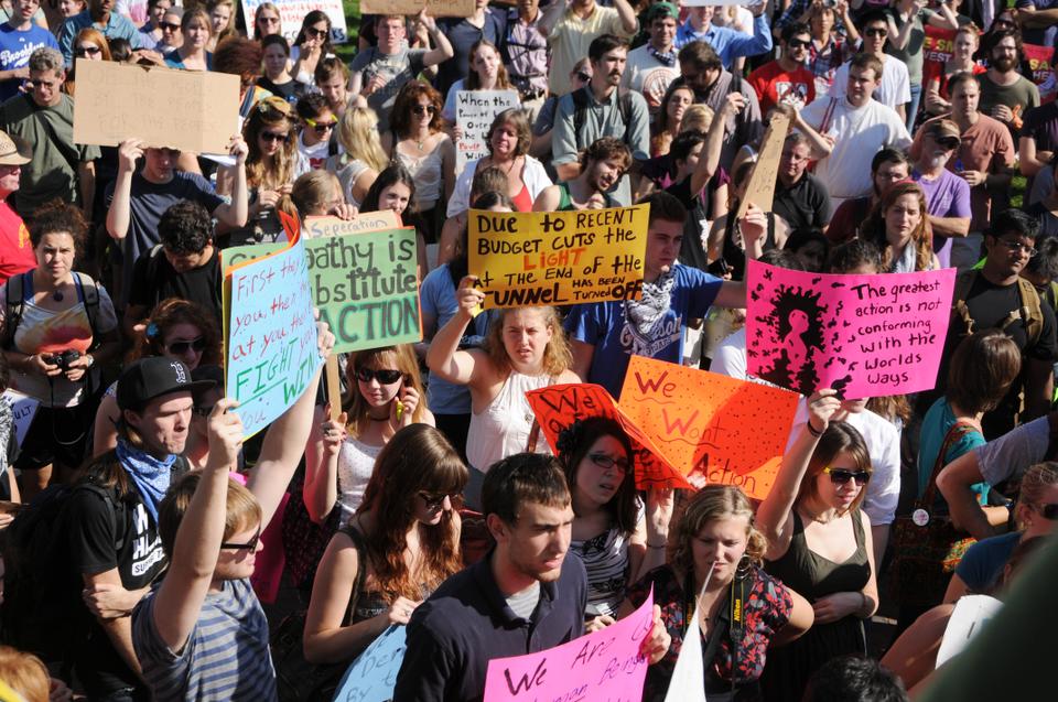 Protesters wave their signs to draw attention to their issues, including financial reform, support for education, and decreased corporate influence in the electoral process. 