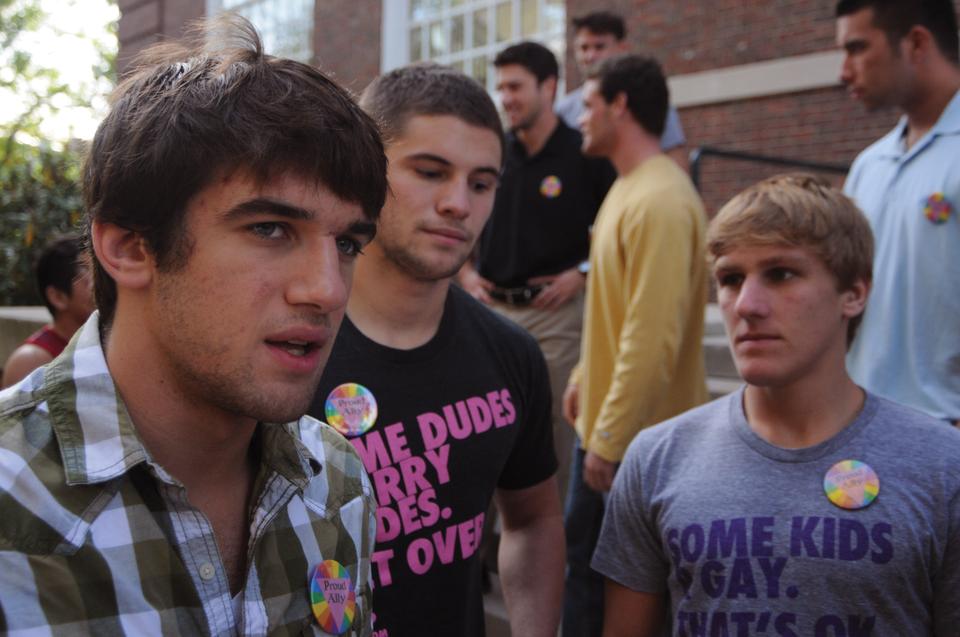 David J. Lalo '13 (left) explains what inspired Anthony J. Buxton '13 (center), Steven M. Keith (right) and him to make t-shirts in support of the LGBTQ community.