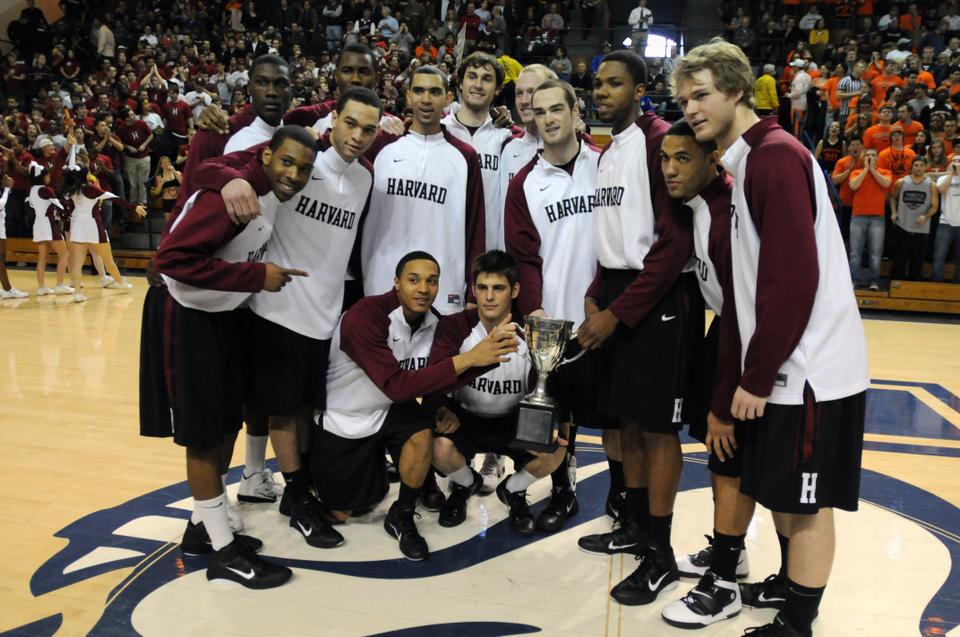 The Harvard men’s basketball team, here holding its first Ivy League Championship trophy, will set a new first tomorrow afternoon as it holds its inaugural “Crimson Madness” event at Lavietes Pavilion.