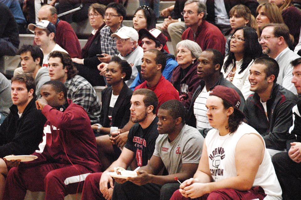 Members of the football team cheer on the basketball players as they showcase their talents at the Crimson Madness scrimmage Saturday afternoon.