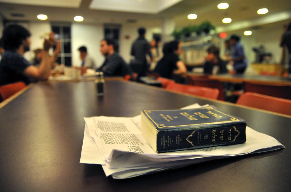 A Jewish prayerbook lies atop a dinner table at Harvard Hillel during the annual Sukkat Salaam interfaith dinner Monday evening. 