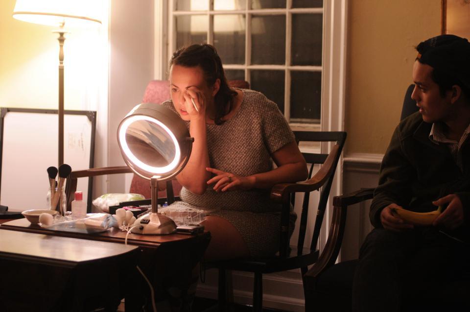 Vanessa Dillen, Kirkland House tutor, presents a makeup tutorial while Lange Luntao '12 watches at the drag workshop in the Kirkland SCR on Monday evening.