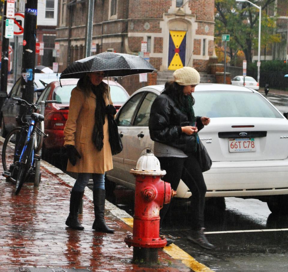 These two gals came equipped with both coats and cameras. Even Cambridge’s all-day rain won’t these tourists from enjoying Harvard‘s campus.