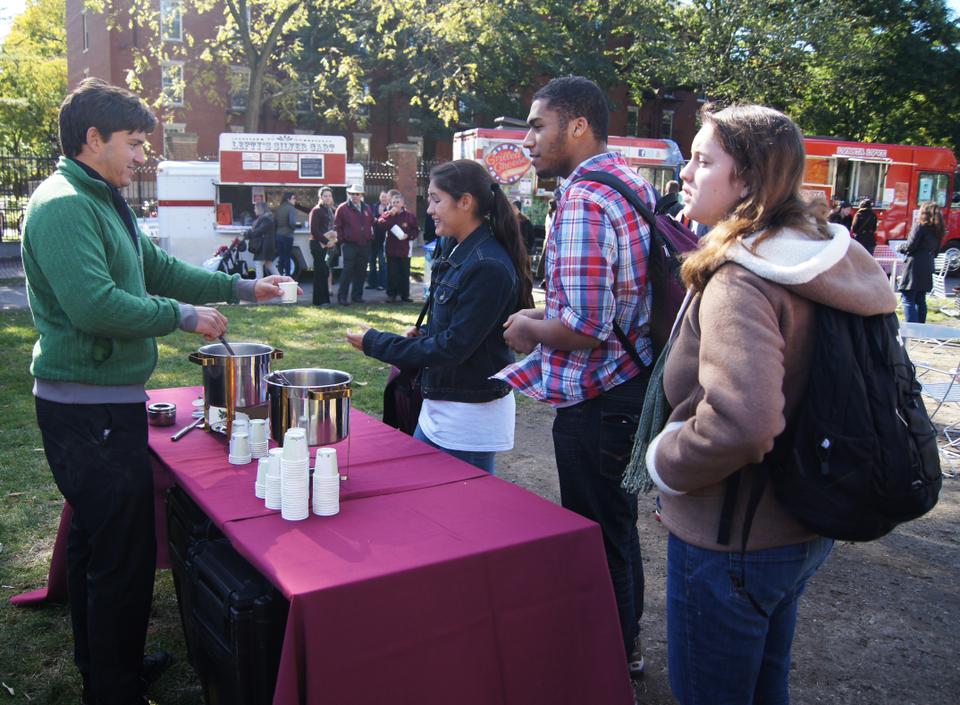 Students enjoy freshly pressed apple cider provided by HUDS, one of several food booths set up in front of the Science Center last Saturday as part of Common Space's Fall Fest.